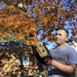
              Liam Kennedy tosses a baseball he stands in his family's front yard Friday, Oct. 28, 2022, in Monroe, Ohio. (AP Photo/Aaron Doster)
            