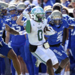 
              Tulane's Shaadie Clayton-Johnson completes a long gain while being forced out of bounds by Tulsa defenders LJ Wallace, left, and Kenney Solomon during an NCAA college football game in Tulsa, Okla. on Saturday, Nov. 5, 2022. (AP Photo/Dave Crenshaw)
            