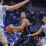 
              UC Riverside's Flynn Cameron (11) drives to the basket against Creighton's Ryan Kalkbrenner (11) and Trey Alexander (23) during the first half of an NCAA college basketball game Thursday, Nov. 17, 2022, in Omaha, Neb. (AP Photo/John Peterson)
            
