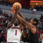 
              Maryland forward Julian Reese attempts to block the shot of Louisville guard Mike James (1) during the first half of an NCAA college basketball game in Louisville, Ky., Tuesday, Nov. 29, 2022. (AP Photo/Timothy D. Easley)
            