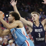 
              Gonzaga forward Anton Watson, left, shoots while defended by North Florida forward Carter Hendricksen during the first half of an NCAA college basketball game, Monday, Nov. 7, 2022, in Spokane, Wash. (AP Photo/Young Kwak)
            