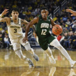 
              Ohio guard Jaylin Hunter, right, dribbles past Michigan guard Jaelin Llewellyn in the first half of an NCAA college basketball game, Sunday, Nov. 20, 2022, in Ann Arbor, Mich. (AP Photo/Jose Juarez)
            