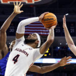
              Auburn forward Johni Broome (4) shoots as Saint Louis forward Francis Okoro, left, and guard Gibson Jimerson (24) try to block the shot during the second half of an NCAA college basketball game Sunday, Nov. 27, 2022, in Auburn, Ala. (AP Photo/Butch Dill)
            