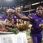 
              Minnesota Vikings cornerback Patrick Peterson (7) grabs a turkey leg off a plate before being interviewed after an NFL football game against the New England Patriots, Thursday, Nov. 24, 2022, in Minneapolis. The Vikings won 33-26. (AP Photo/Bruce Kluckhohn)
            