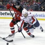 
              Washington Capitals defenseman Trevor van Riemsdyk (57) clears the puck in front of New Jersey Devils center Yegor Sharangovich during the second period of an NHL hockey game Saturday, Nov. 26, 2022, in Newark, N.J. (AP Photo/Adam Hunger)
            