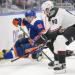 
              Arizona Coyotes' J.J. Moser (90) fights for control of the puck with New York Islanders' Casey Cizikas (53) during the second period of an NHL hockey game Thursday, Nov. 10, 2022, in Elmont, N.Y. (AP Photo/Frank Franklin II)
            