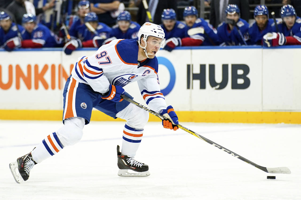 Edmonton Oilers center Connor McDavid skates with the puck during the first period of an NHL hockey...
