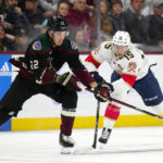 
              Arizona Coyotes center Jack McBain (22) battles with Florida Panthers center Anton Lundell (15) for the puck during the first period of an NHL hockey game in Tempe, Ariz., Tuesday, Nov. 1, 2022. (AP Photo/Ross D. Franklin)
            