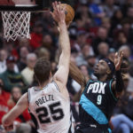 
              Portland Trail Blazers forward Jerami Grant, right, shoots over San Antonio Spurs center Jakob Poeltl during the second half of an NBA basketball game in Portland, Ore., Tuesday, Nov. 15, 2022. (AP Photo/Craig Mitchelldyer)
            