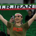 
              A fan holds up a scarf prior the start of the World Cup group B soccer match between Iran and the United States at the Al Thumama Stadium in Doha, Qatar, Tuesday, Nov. 29, 2022. (AP Photo/Manu Fernandez)
            