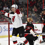 
              New Jersey Devils right wing Nathan Bastian (14) celebrates his goal as Ottawa Senators goaltender Anton Forsberg (31) looks on during first period of an NHL hockey game in Ottawa, on Saturday, Nov. 19, 2022.  (Justin Tang /The Canadian Press via AP)
            