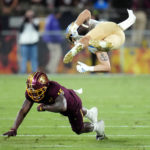 
              Arizona State defensive back Khoury Bethley (15) flips UCLA wide receiver Kazmeir Allen during the first half of an NCAA college football game in Tempe, Ariz., Saturday, Nov. 5, 2022. (AP Photo/Ross D. Franklin)
            