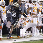 
              Vanderbilt's Jayden McGowan (16) is knocked out of bounds by Tennessee's Paxton Brooks (37) during the first half of an NCAA college football game Saturday, Nov. 26, 2022, in Nashville, Tenn. (AP Photo/Wade Payne)
            