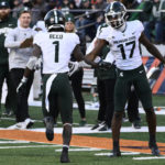 
              Michigan State wide receiver Tre Mosley (17) high-fives wide receiver Jayden Reed (1) after Reed scored a touchdown against Illinois during the second half of an NCAA college football game, Saturday, Nov. 5, 2022, in Champaign, Ill. (AP Photo/Matt Marton)
            