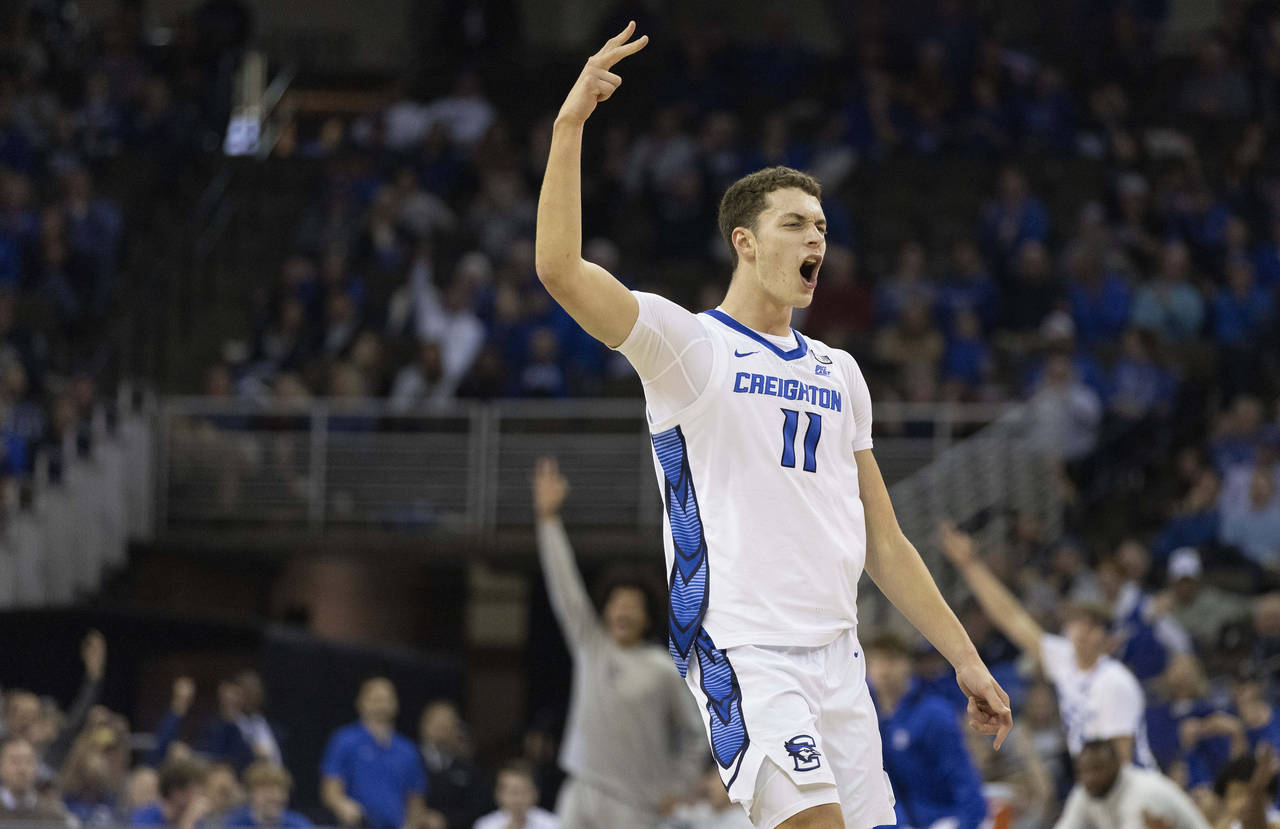 Creighton's Ryan Kalkbrenner (11) reacts after hitting a 3-point basket against Holy Cross during t...