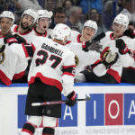 
              Ottawa Senators center Dylan Gambrell (27) celebrates with the bench after his goal against the Tampa Bay Lightning during the first period of an NHL hockey game Tuesday, Nov. 1, 2022, in Tampa, Fla. (AP Photo/Chris O'Meara)
            
