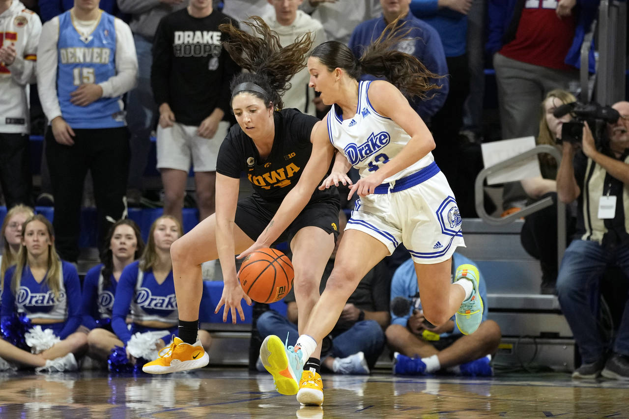 Drake forward Grace Berg (43) steals the ball from Iowa forward McKenna Warnock, left, during the f...