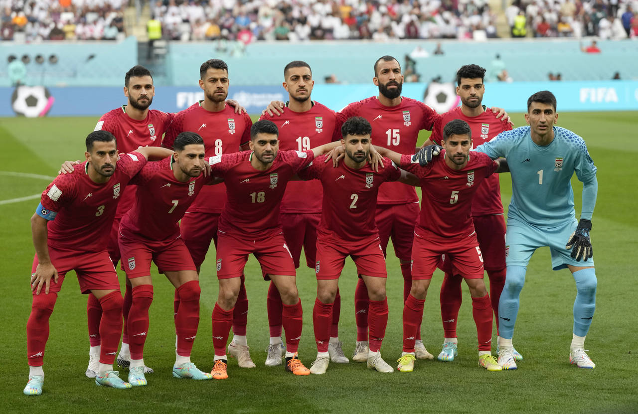Iranian players pose ahead of the World Cup group B soccer match between England and Iran at the Kh...