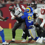 
              Los Angeles Rams defensive tackle Aaron Donald (99) sacks Tampa Bay Buccaneers quarterback Tom Brady (12) during the second half of an NFL football game between the Los Angeles Rams and Tampa Bay Buccaneers, Sunday, Nov. 6, 2022, in Tampa, Fla. (AP Photo/Chris O'Meara)
            