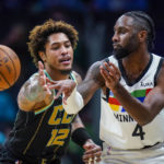 
              Charlotte Hornets guard Kelly Oubre Jr. (12) defends as Minnesota Timberwolves guard Jaylen Nowell (4) passes the ball during the first half of an NBA basketball game Friday, Nov. 25, 2022, in Charlotte, N.C. (AP Photo/Rusty Jones)
            