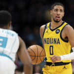 
              Indiana Pacers guard Tyrese Haliburton (0) brings the ball up while guarded by Charlotte Hornets guard Theo Maledon (9) during the second half of an NBA basketball game in Charlotte, N.C., Wednesday, Nov. 16, 2022. (AP Photo/Jacob Kupferman)
            