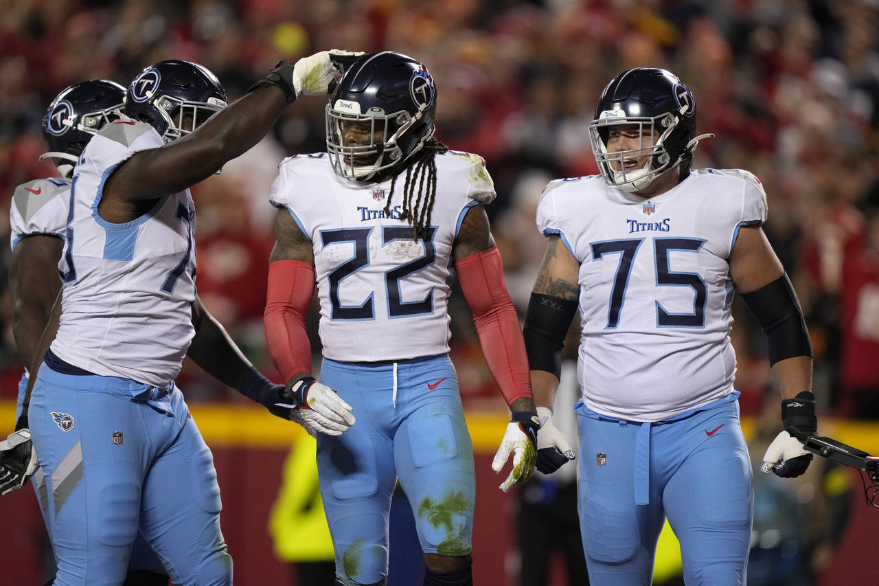 Tennessee Titans running back Derrick Henry (22) is congratulated by teammates after scoring during...