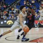 
              Xavier guard Desmond Claude, left, dribbles around Florida guard Kyle Lofton during the first half of an NCAA college basketball game in the Phil Knight Legacy tournament in Portland, Ore., Thursday, Nov. 24, 2022. (AP Photo/Craig Mitchelldyer)
            