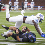 
              SMU quarterback Tanner Mordecai (8) is brought down by Memphis linebacker Tyler Murray (5) during the first half of an NCAA college football game at Ford Stadium on Saturday, Nov. 26, 2022, in Dallas. (Smiley N. Pool/The Dallas Morning News via AP)
            