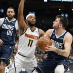 
              Denver Nuggets forward Bruce Brown (11) defends Dallas Mavericks guard Luka Doncic (77) during the first half of an NBA basketball game in Dallas, Sunday, Nov. 20, 2022. (AP Photo/LM Otero)
            