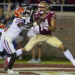 
              Florida State wide receiver Johnny Wilson (14) is unable to hold onto a pass in the end zone as Florida safety Kamari Wilson (5) defends in the first quarter of an NCAA college football game, Friday, Nov. 25, 2022, in Tallahassee, Fla. (AP Photo/Phil Sears)
            