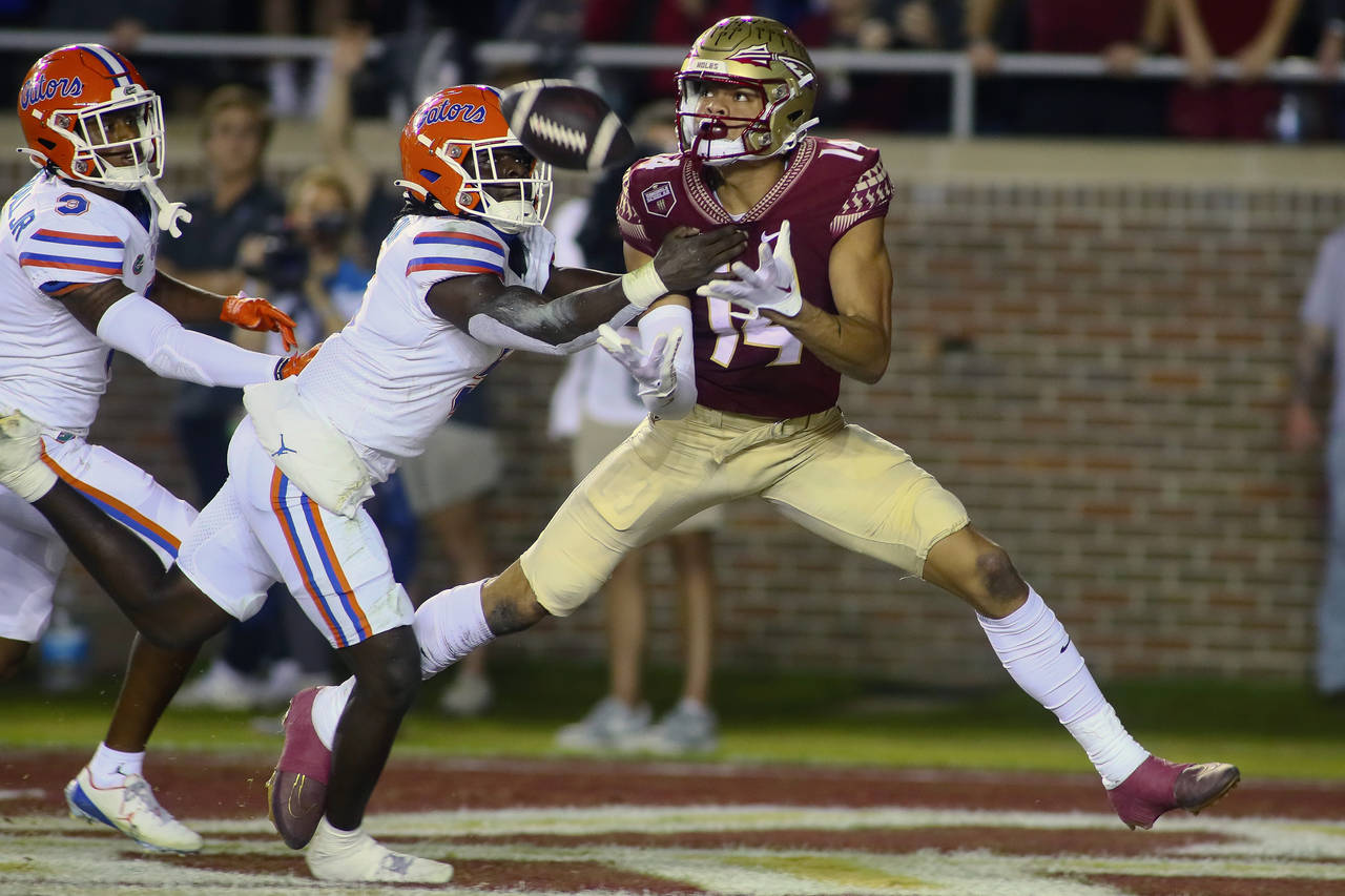 Florida State wide receiver Johnny Wilson (14) is unable to hold onto a pass in the end zone as Flo...