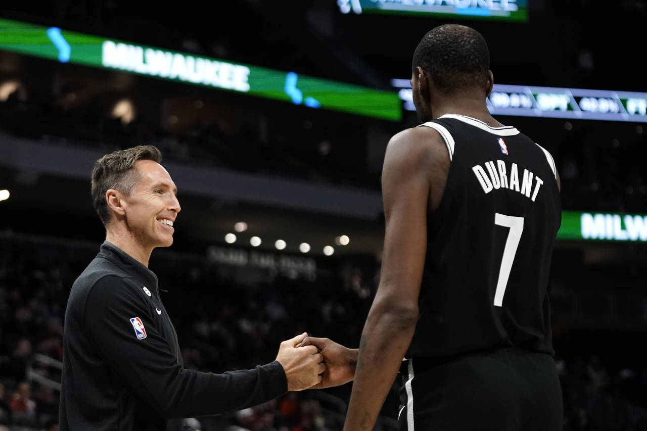 Brooklyn Nets coach Steve Nash laughs with Kevin Durant (7) during the second half of the team's NB...
