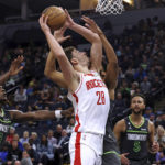 
              Houston Rockets center Alperen Sengun (28) goes to the basket against Minnesota Timberwolves center Karl-Anthony Towns, mostly obscured, during the second half of an NBA basketball game Saturday, Nov. 5, 2022, in Minneapolis. The Timberwolves won 129-117. (AP Photo/Stacy Bengs)
            