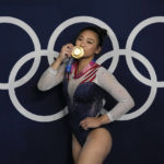 
              FILE - Sunisa Lee, of United States, reacts as she poses for a picture after winning the gold medal in the artistic gymnastics women's all-around final at the 2020 Summer Olympics, July 29, 2021, in Tokyo. The 2020 women's all-around gymnastics champion announced Tuesday, Nov. 15, 2022, that she will return to training at the elite level following the end of her sophomore season at Auburn next spring. (AP Photo/Gregory Bull, File)
            