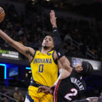 
              Indiana Pacers guard Tyrese Haliburton (0) shoots over Miami Heat guard Gabe Vincent (2) during the second half of an NBA basketball game in Indianapolis, Friday, Nov. 4, 2022. The Pacers defeated the Heat 101-99. (AP Photo/Michael Conroy)
            