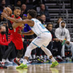 
              Portland Trail Blazers guard Damian Lillard (0) is guarded by Charlotte Hornets guard Dennis Smith Jr. (8) during the first half of an NBA basketball game Wednesday, Nov. 9, 2022, in Charlotte, N.C. (AP Photo/Scott Kinser)
            