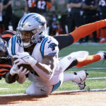 
              Carolina Panthers tight end Tommy Tremble (82) makes a touchdown catch as Cincinnati Bengals safety Dax Hill (23) defends during the second half of an NFL football game, Sunday, Nov. 6, 2022, in Cincinnati. (AP Photo/Joshua A. Bickel)
            