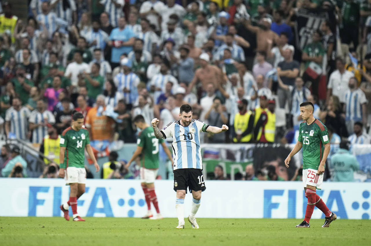 Argentina's Lionel Messi celebrates after his team won the World Cup group C soccer match between A...