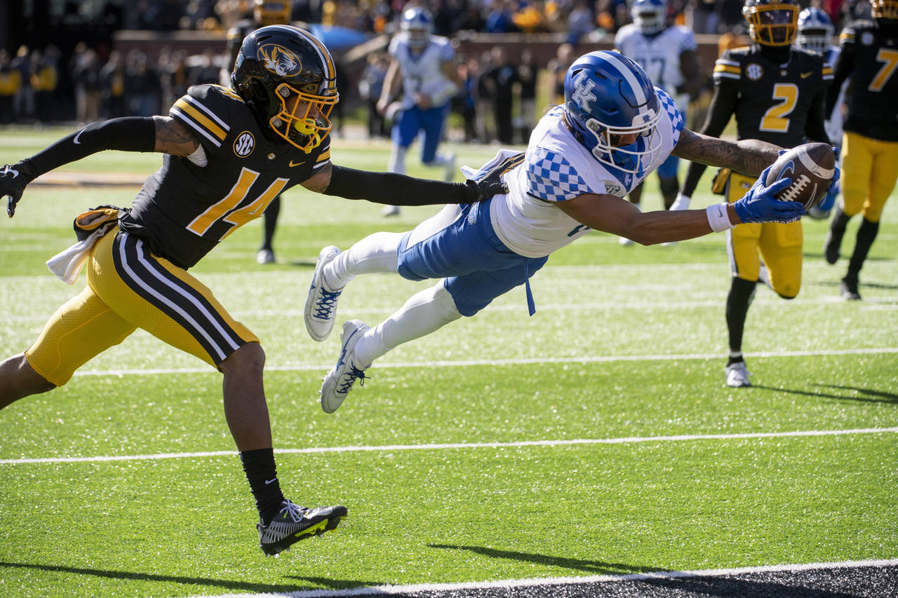 Kentucky wide receiver Dane Key, right, dives over the goal line for a touchdown in front of Missou...