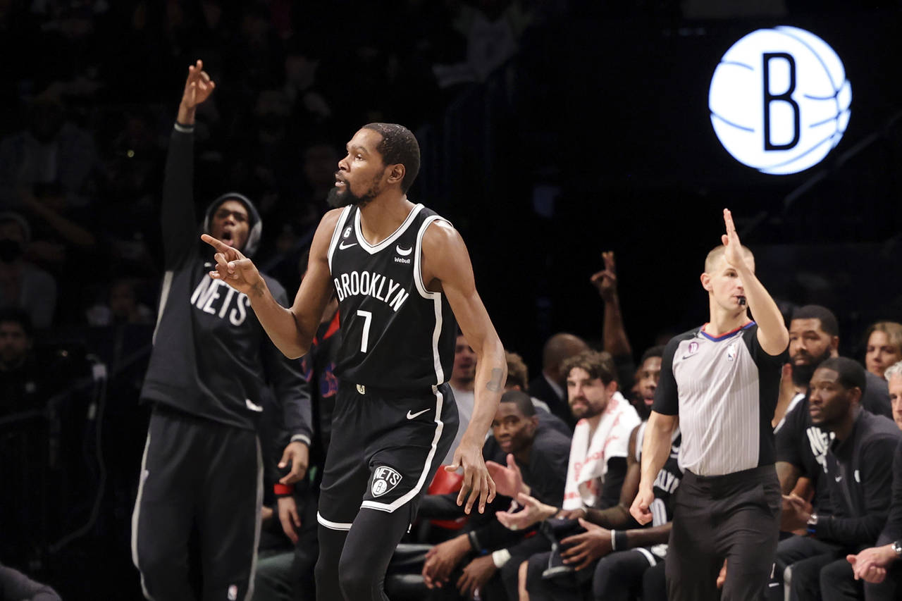 Brooklyn Nets forward Kevin Durant (7) reacts after scoring a 3-point shot against the Portland Tra...