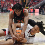 
              Maryland guard Ian Martinez battles Louisville guard Fabio Basili for a loose ball during the second half of an NCAA college basketball game in Louisville, Ky., Tuesday, Nov. 29, 2022. Maryland won 79-54. (AP Photo/Timothy D. Easley)
            