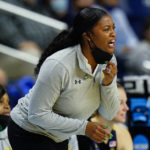 
              FILE - Notre Dame head coach Niele Ivey shouts to players during the first half of a college basketball game against North Carolina State in the Sweet Sixteen round of the NCAA women's tournament, Saturday, March 26, 2022, in Bridgeport, Conn.  The Atlantic Coast and Southeastern conferences have led the way among the power conferences in hiring coaches of color to lead women’s basketball programs. (AP Photo/Frank Franklin II, File)
            