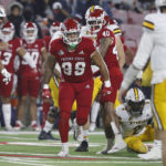 
              Fresno State defensive end David Perales celebrates a third-down stop, as Wyoming quarterback Andrew Peasley, right, stands nearby during the first half of an NCAA college football game in Fresno, Calif., Friday, Nov. 25, 2022. (AP Photo/Gary Kazanjian)
            