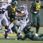 
              Kansas State running back Deuce Vaughn (22) breaks free from Baylor cornerback Mark Milton in the first half of an NCAA college football game, Saturday, Nov. 12, 2022, in Waco, Texas. (AP Photo/Jerry Larson)
            