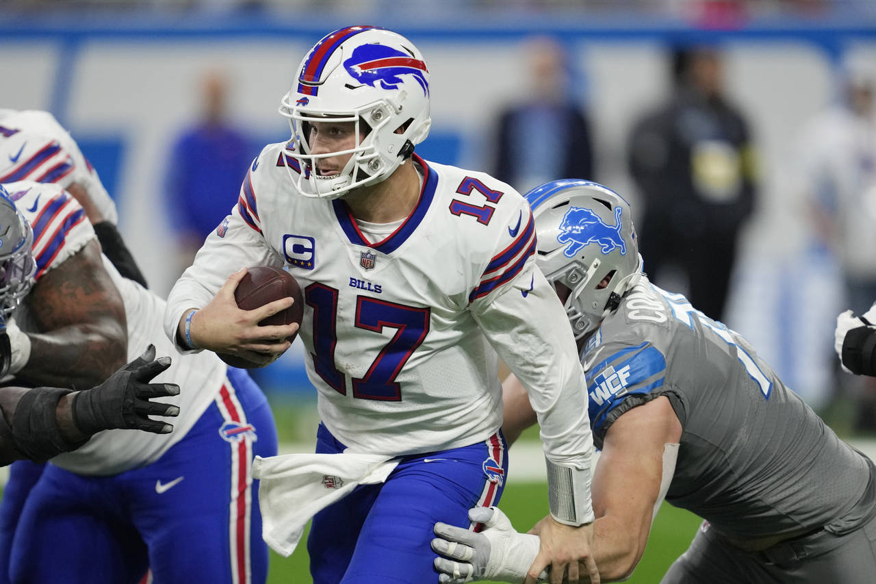 Buffalo Bills quarterback Josh Allen scrambles during the second half of an NFL football game again...