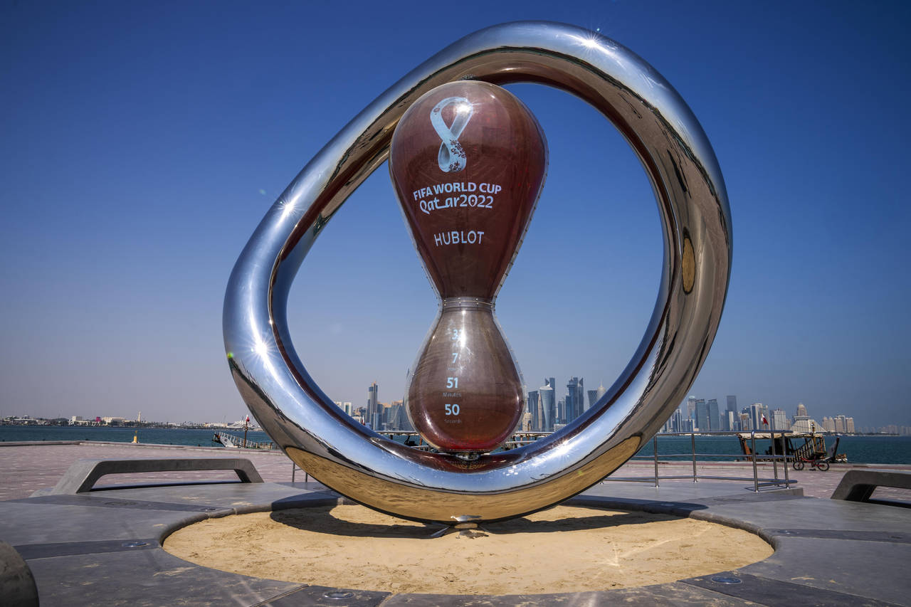 FILE - The official FIFA World Cup Countdown Clock on Doha's corniche, overlooking the skyline of D...