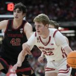 
              Wisconsin's Steven Crowl drives past Stanford's Maxime Raynaud during the first half of an NCAA college basketball game Friday, Nov. 11, 2022, in Milwaukee. The game is being played at American Family Field, home of the Milwaukee Brewers. (AP Photo/Morry Gash)
            