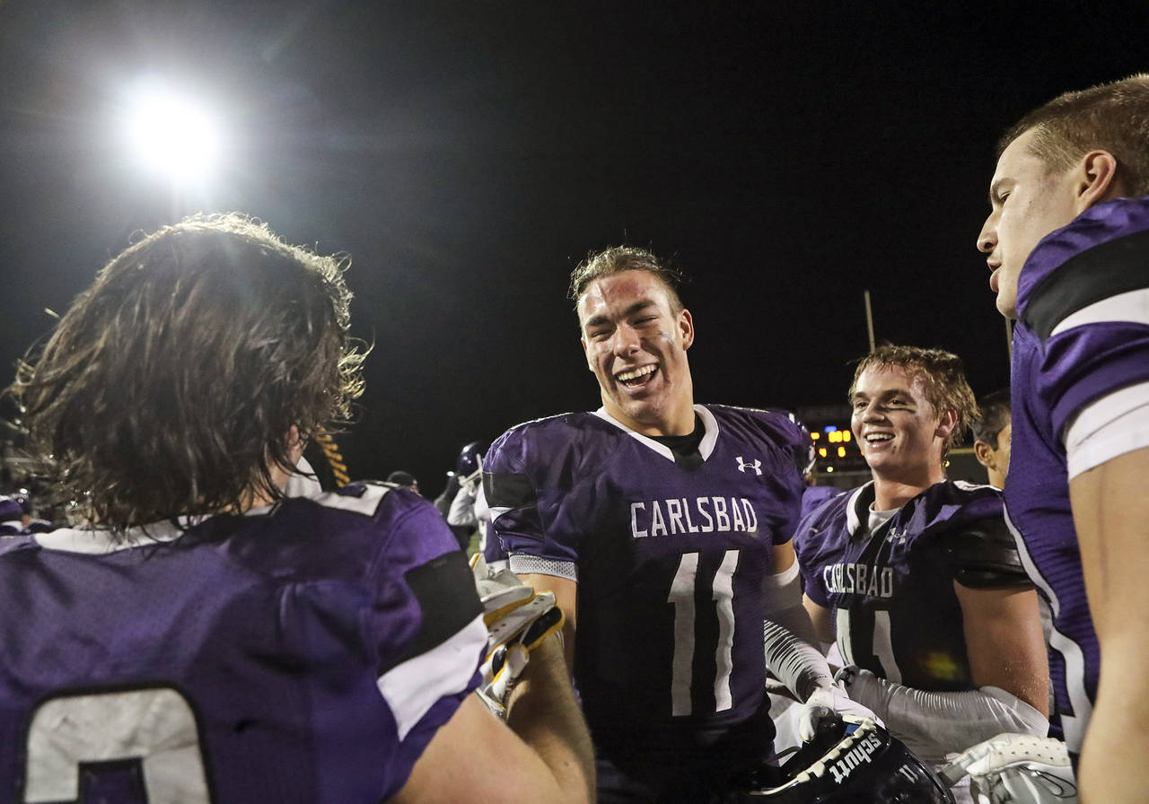 Carlsbad's Zachary Marshall (11) and teammates celebrate beating Poway after their Open Division pl...