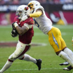 
              Arizona Cardinals running back James Conner (6) eludes the tackle of Los Angeles Chargers safety Derwin James Jr. during the second half of an NFL football game, Sunday, Nov. 27, 2022, in Glendale, Ariz. (AP Photo/Ross D. Franklin)
            