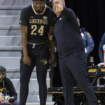 
              Lindenwood head coach Kyle Gerdeman, right, instructs Kennon Cole, left, during the first half of an NCAA college basketball game against Missouri, Sunday, Nov. 13, 2022, in Columbia, Mo. Missouri won 82-53. (AP Photo/L.G. Patterson)
            